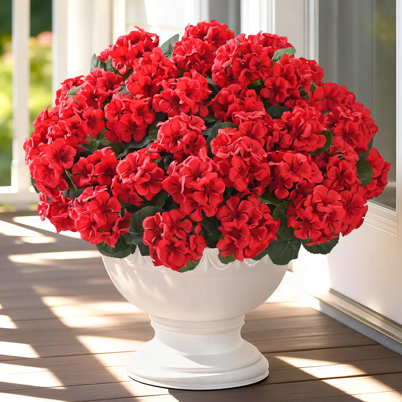 Red Artificial Geranium Blooms in White Urn Pot